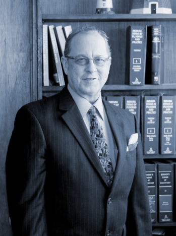 Portrait of attorney standing in front of law bookshelves